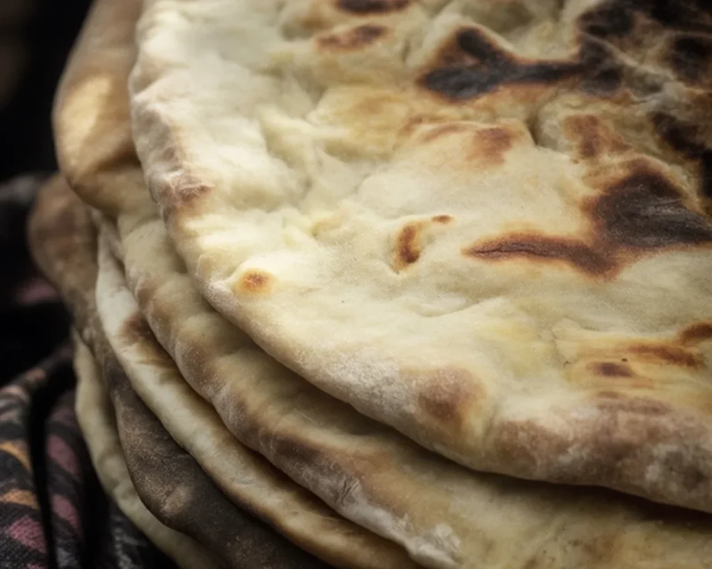 Gluten-Free Millet Pan Bread fresh out of the oven, ready to be sliced.