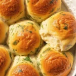 Pillowy-soft gluten-free cheddar cheese dinner rolls brushed with garlic butter.