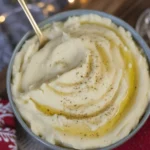 Homemade gluten free bread sauce served in a bowl with garnishes.