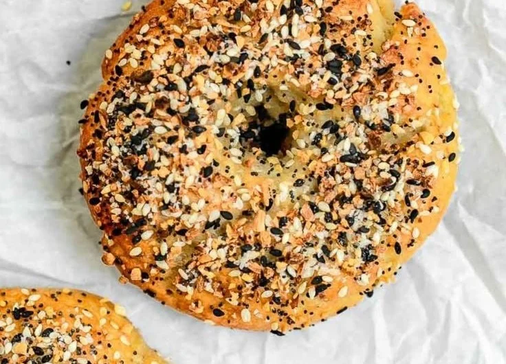 Freshly baked gluten-free bagels on a wooden table