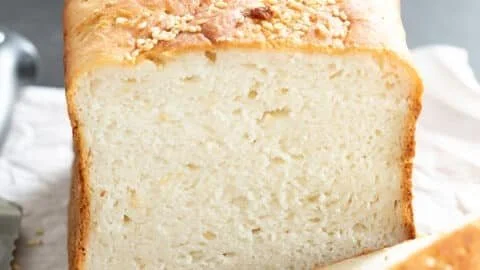 Homemade gluten free bread sliced on a wooden board