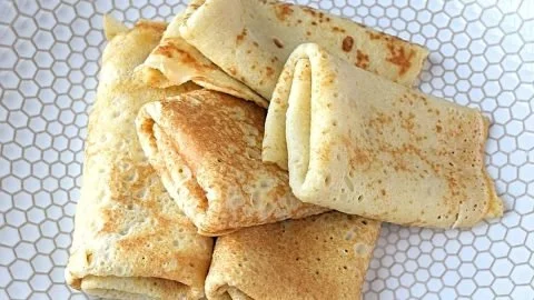 Delicious gluten free crepes filled with fresh berries and whipped cream