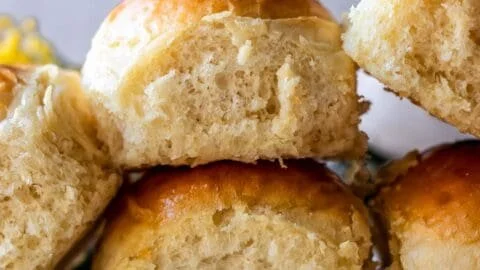 Freshly baked gluten-free dinner rolls on a wooden table