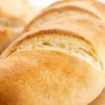 Gluten free French bread baguettes baked to perfection on a wooden board