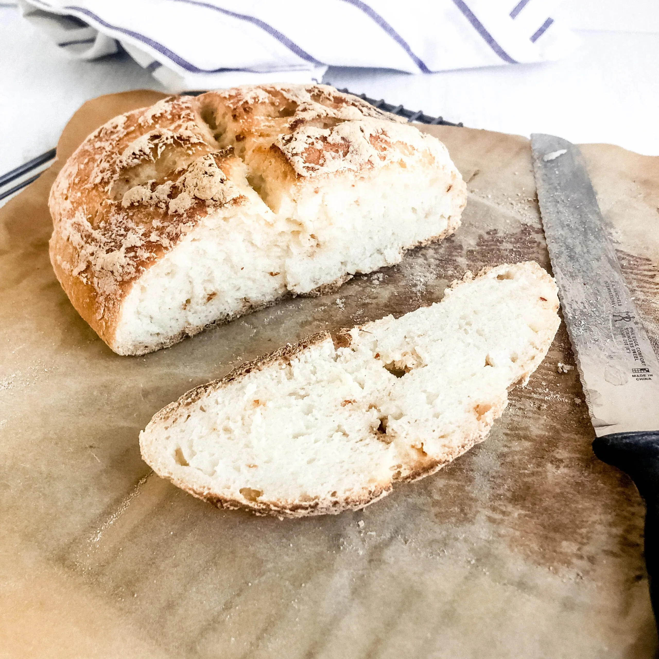 Freshly baked gluten-free no knead bread on a wooden table.