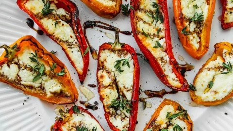 Delicious goat cheese stuffed mini peppers appetizer on a serving platter.