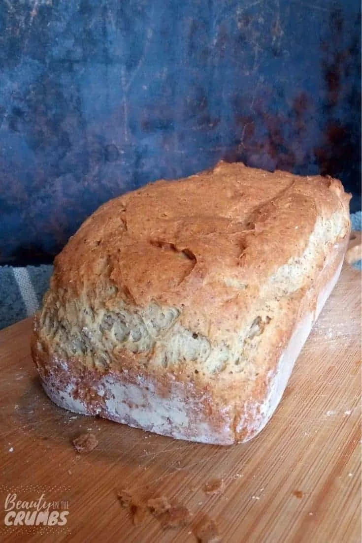 Loaf of soft gluten free sandwich bread sliced on a wooden cutting board